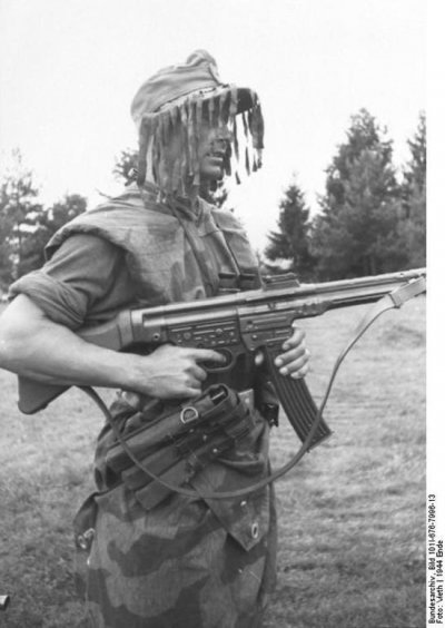 Stg.44 - German wearing splinter camouflage and a ghillie cap